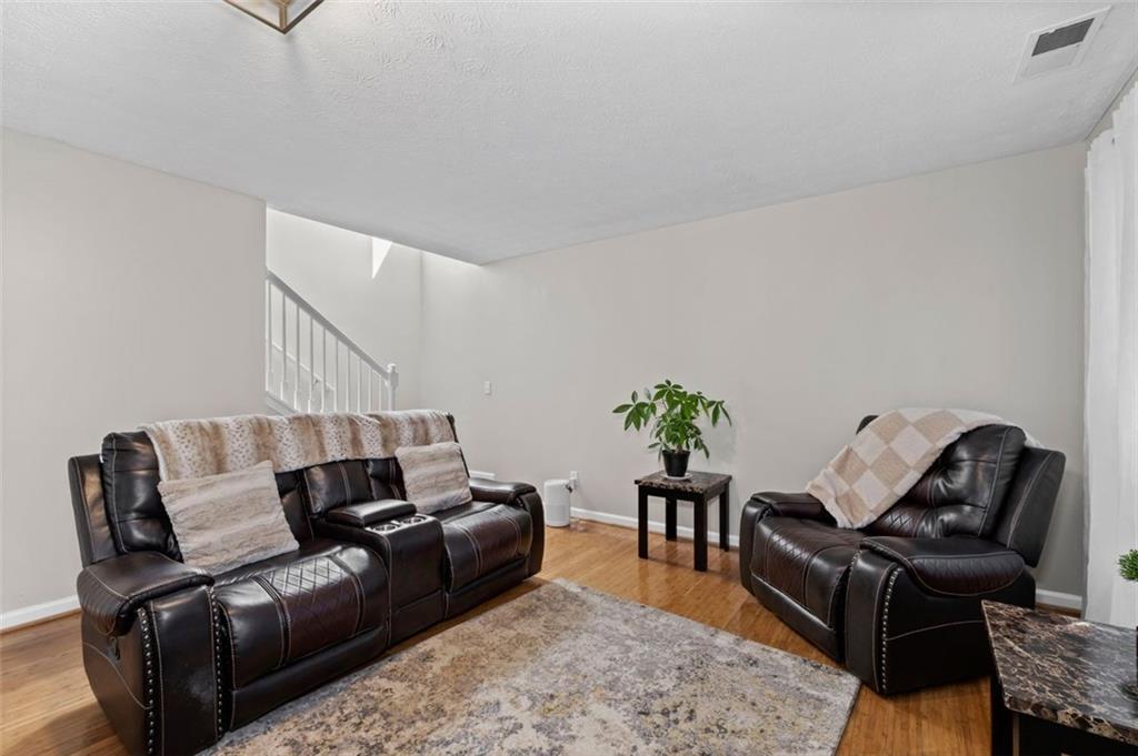 6115 Riveroak Terrace Atlanta, GA 30349 - Photo 20 of 41 a living room with furniture rug and wooden floor