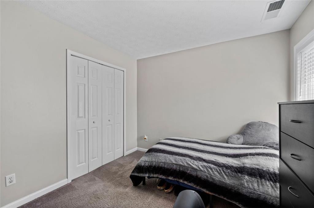 6115 Riveroak Terrace Atlanta, GA 30349 - Photo 23 of 41 a bedroom with a bed and window