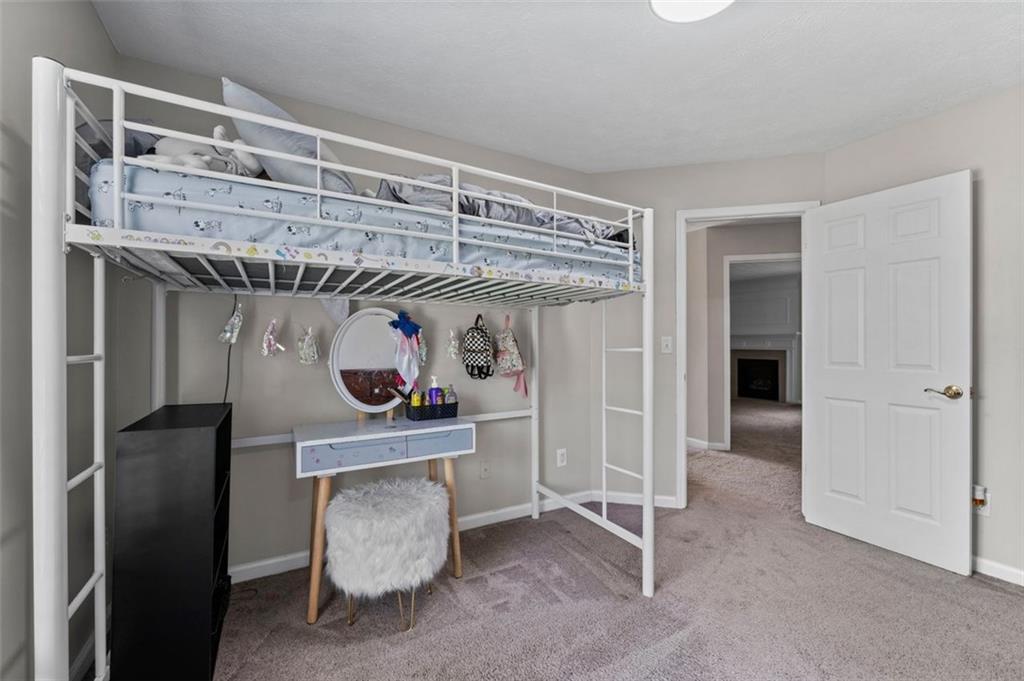 6115 Riveroak Terrace Atlanta, GA 30349 - Photo 26 of 41 a living room with furniture and a chandelier
