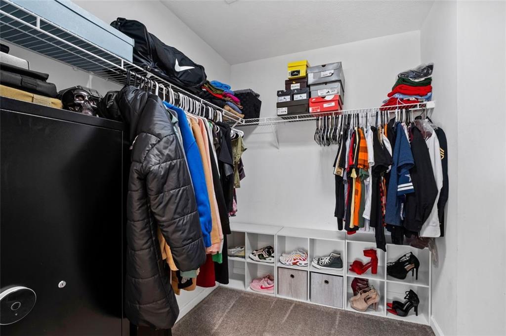 6115 Riveroak Terrace Atlanta, GA 30349 - Photo 35 of 41 a view of walk in closet with clothes and shoes