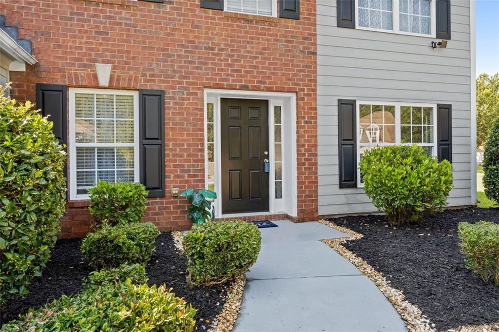 6115 Riveroak Terrace Atlanta, GA 30349 - Photo 4 of 41 a front view of a house with garden