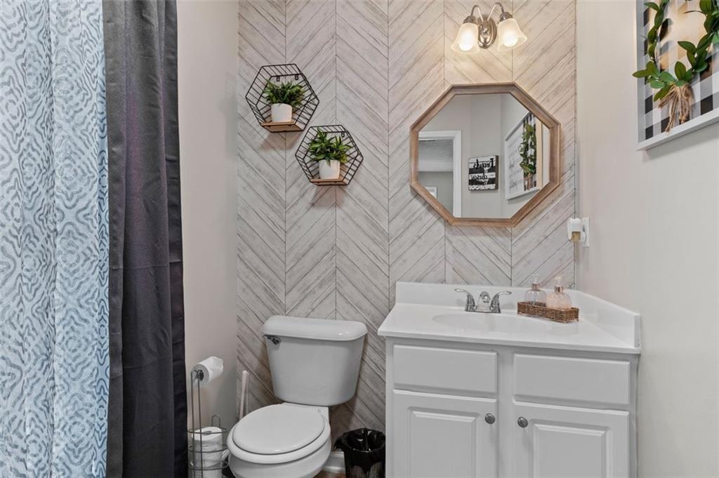 6115 Riveroak Terrace Atlanta, GA 30349 - Photo 7 of 41 a bathroom with a toilet sink and mirror