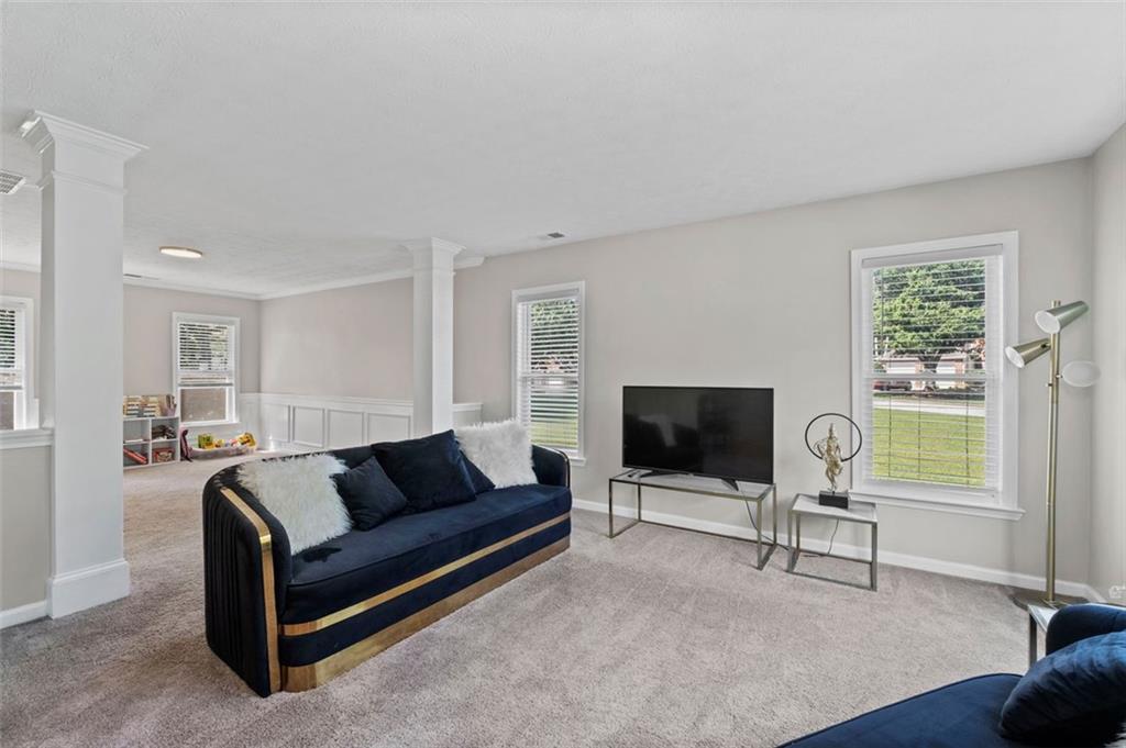 6115 Riveroak Terrace Atlanta, GA 30349 - Photo 8 of 41 a living room with furniture and a flat screen tv
