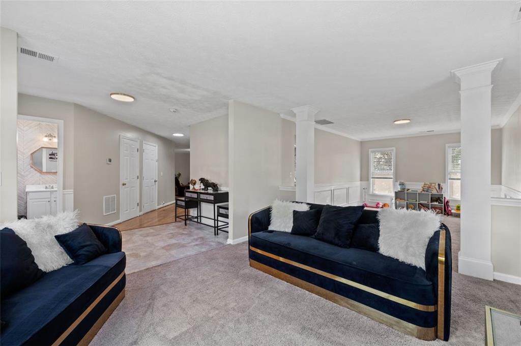 6115 Riveroak Terrace Atlanta, GA 30349 - Photo 9 of 41 a living room with furniture and a dining table with kitchen view