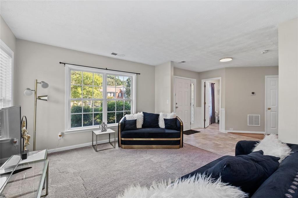 6115 Riveroak Terrace Atlanta, GA 30349 - Photo 10 of 41 a living room with furniture and a large window
