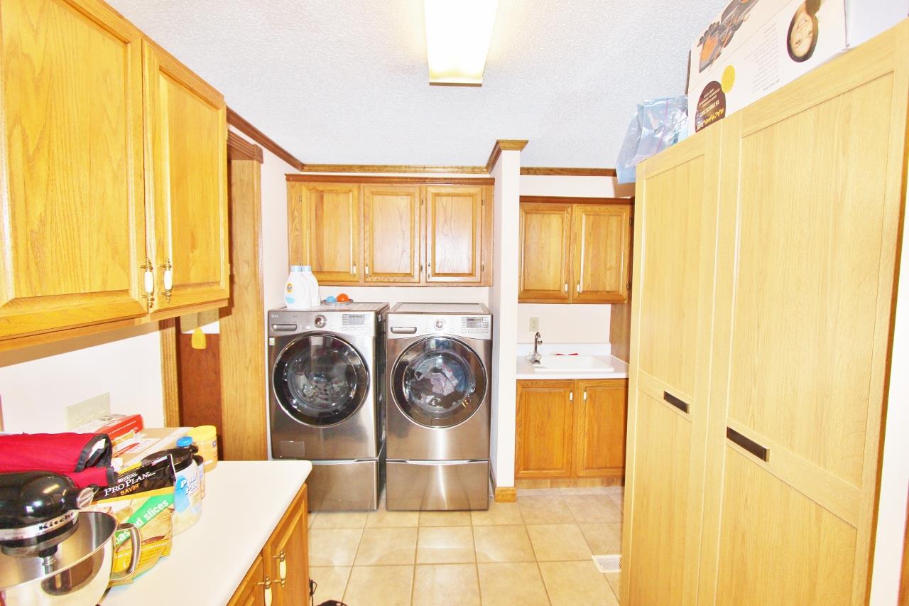 6830 Beasleys Bend Road Lebanon, TN 37087 - Photo 12 of 30 a bathroom with a sink a washer and dryer next to a window