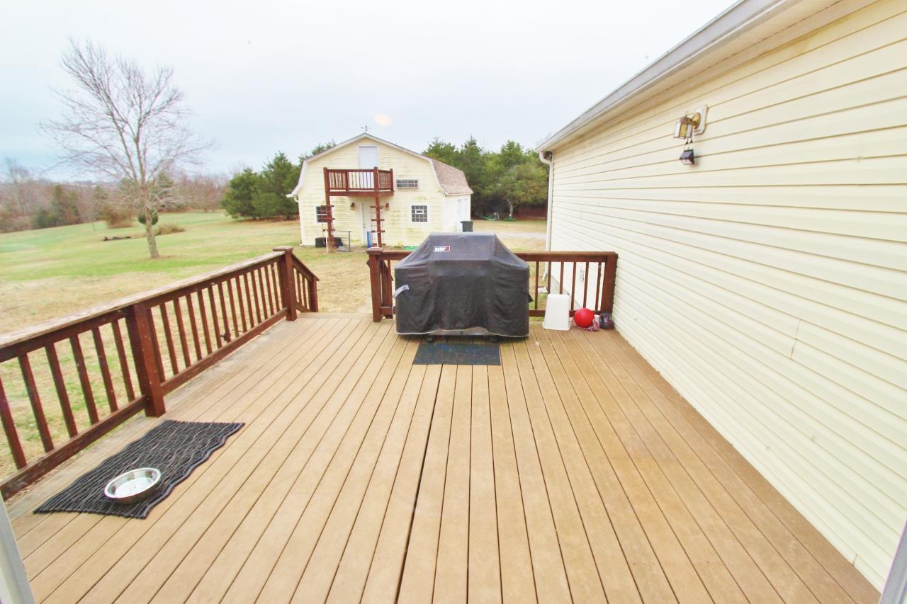 6830 Beasleys Bend Road Lebanon, TN 37087 - Photo 14 of 30 a view of a roof deck with wooden floor and fence