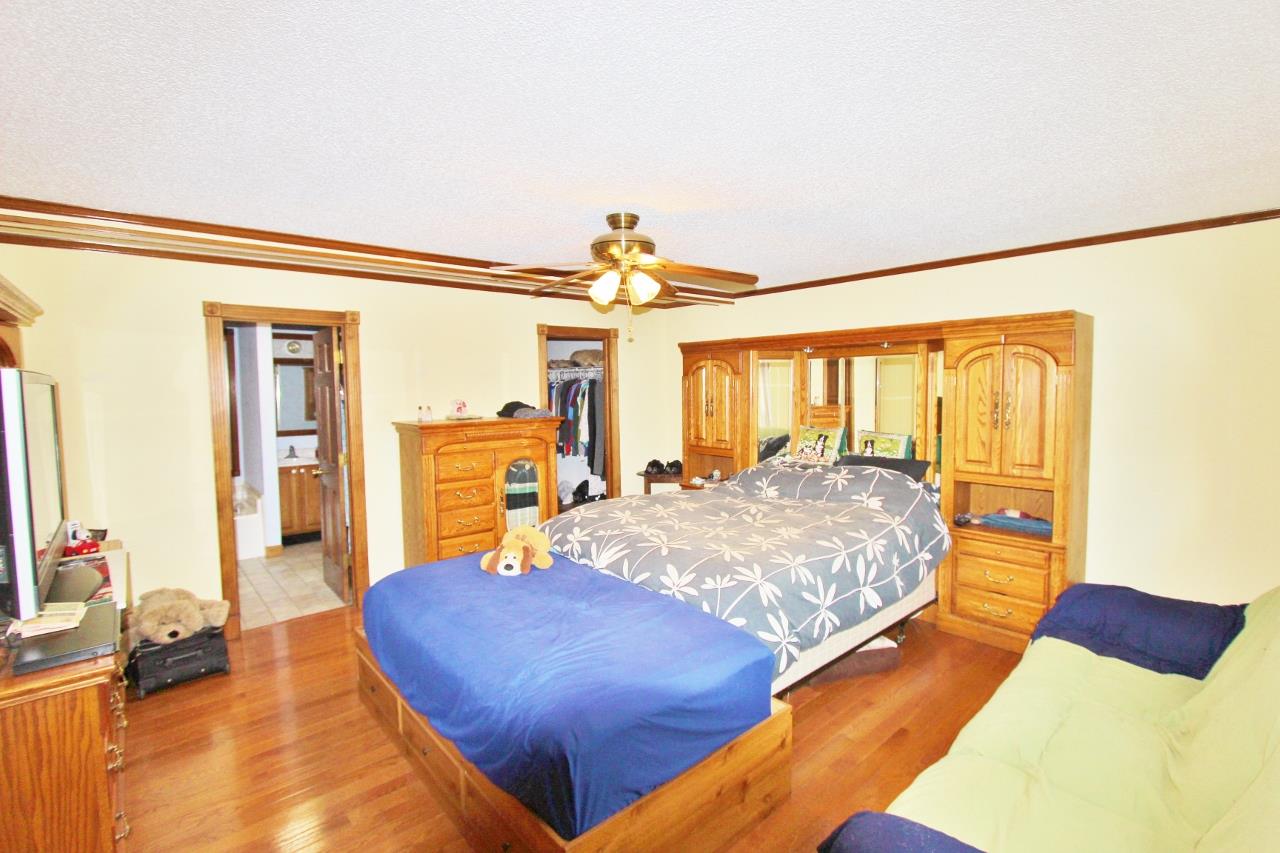 6830 Beasleys Bend Road Lebanon, TN 37087 - Photo 19 of 30 a bedroom with a bed and wooden floor