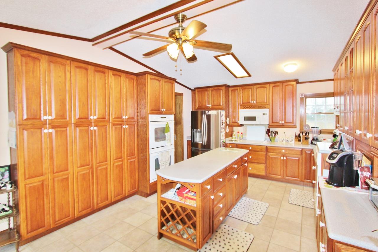 6830 Beasleys Bend Road Lebanon, TN 37087 - Photo 7 of 30 a large kitchen with kitchen island granite countertop a large window cabinets and stainless steel appliances