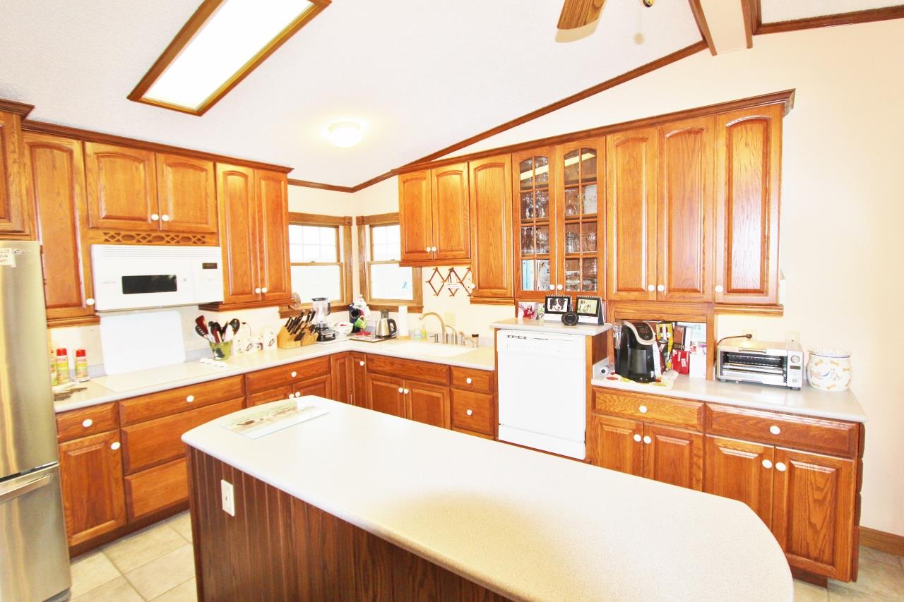 6830 Beasleys Bend Road Lebanon, TN 37087 - Photo 8 of 30 a kitchen with a sink a counter top space cabinets stainless steel appliances and a large window