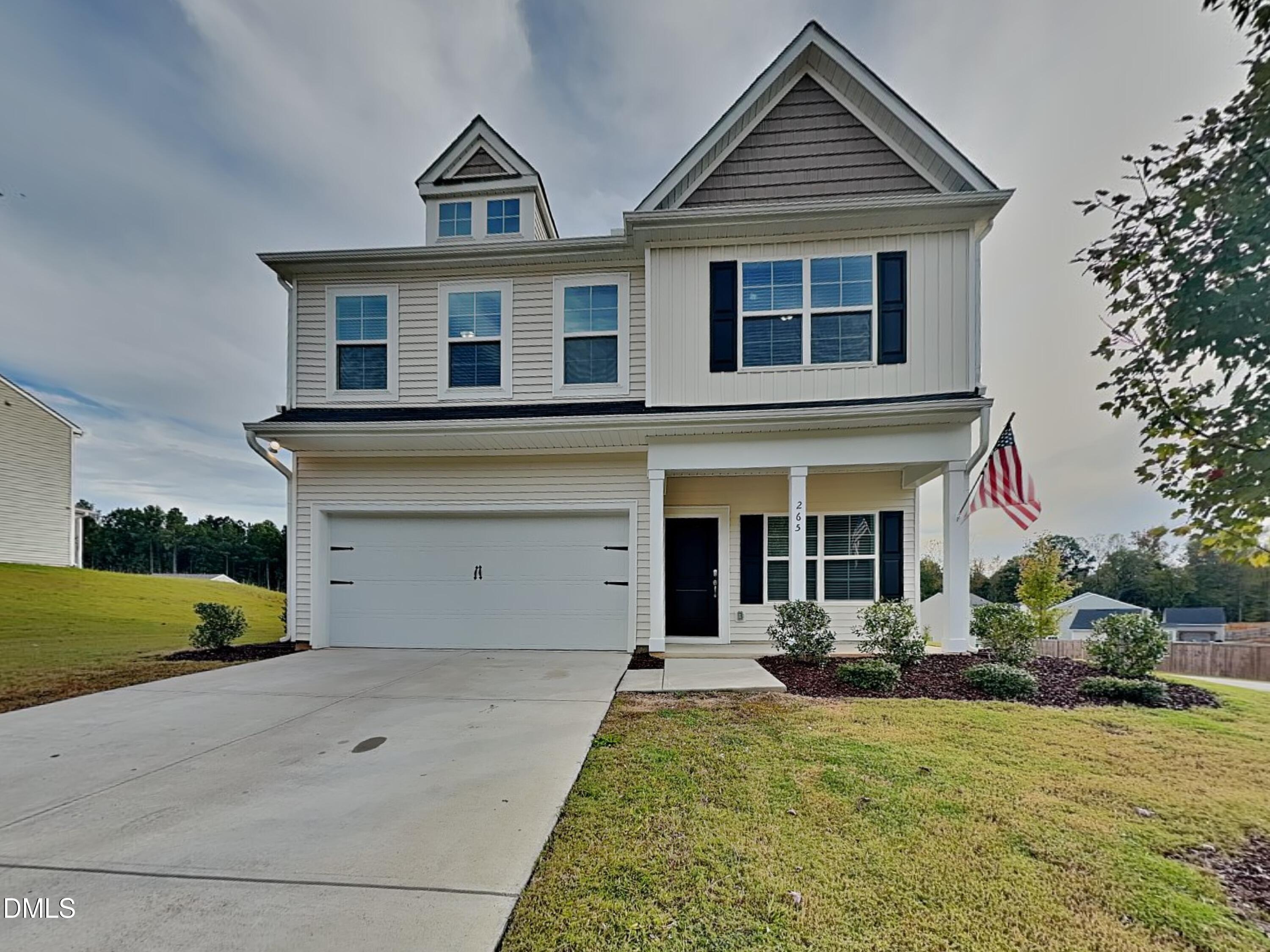 265 Frst Mdw Lane Franklinton, NC 27525 - Photo 1 of 17 a front view of a house with garden