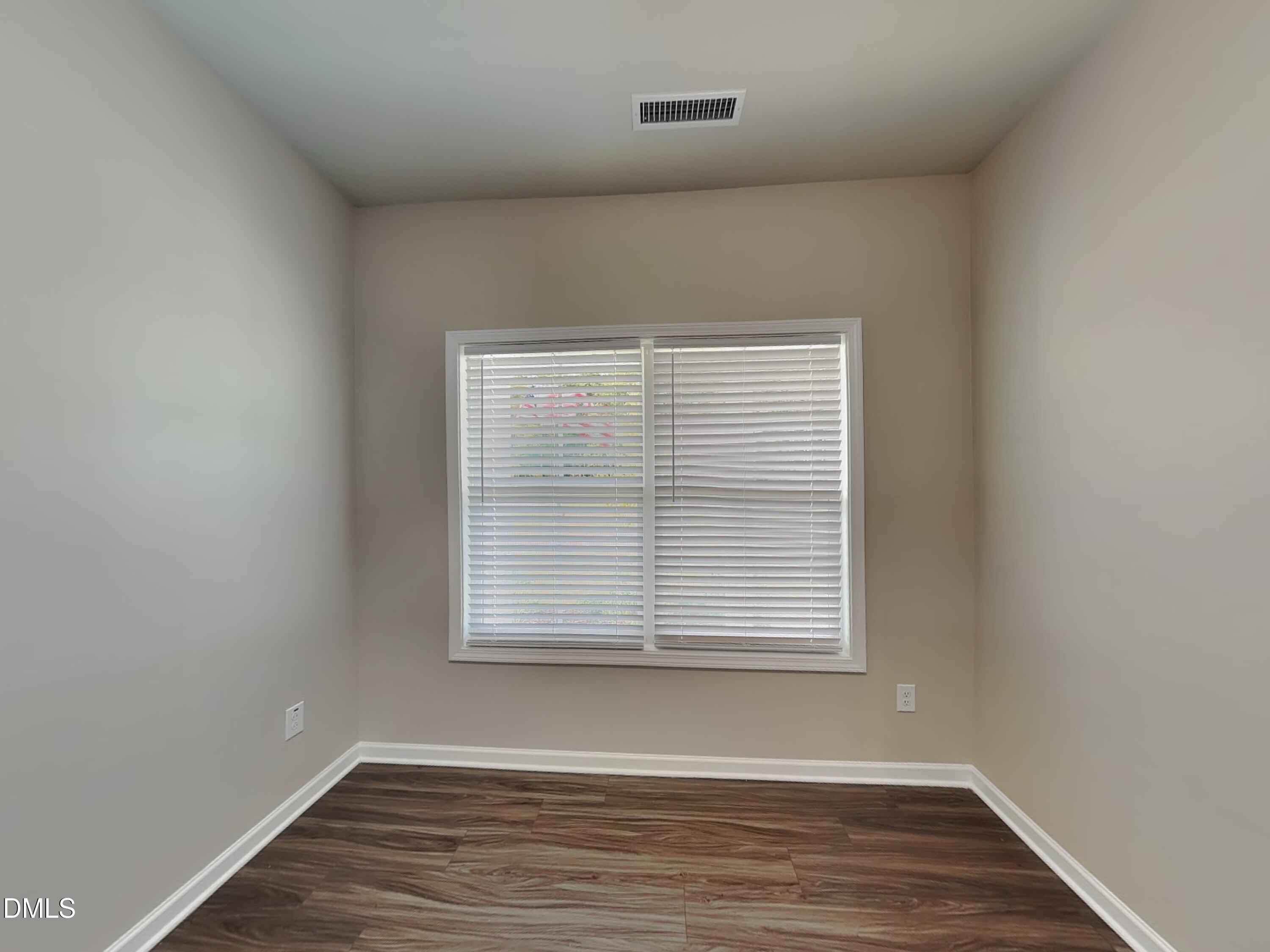 265 Frst Mdw Lane Franklinton, NC 27525 - Photo 14 of 17 an empty room with wooden floor and windows