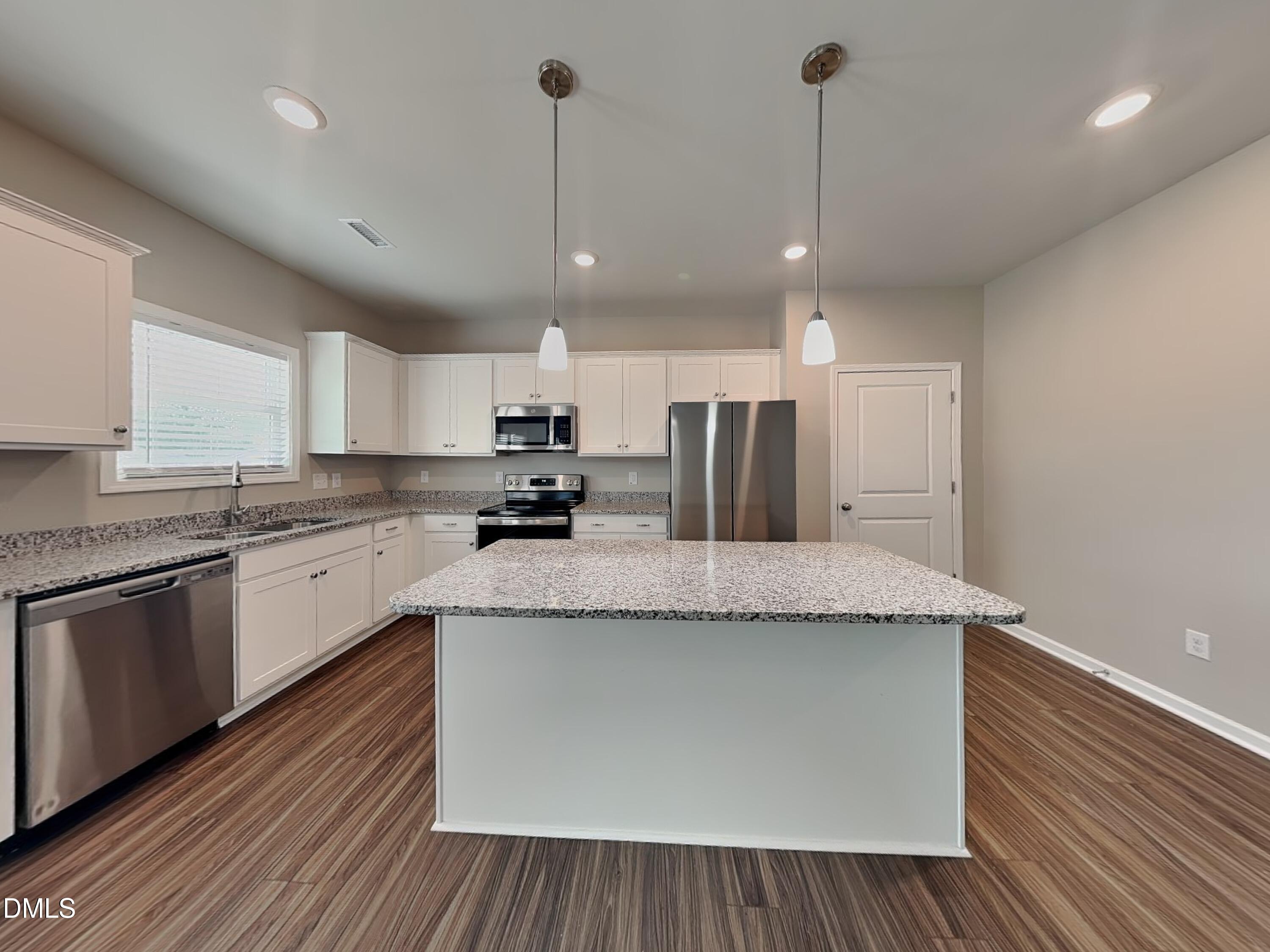 265 Frst Mdw Lane Franklinton, NC 27525 - Photo 4 of 17 a large kitchen with granite countertop a island a sink stainless steel appliances and cabinets