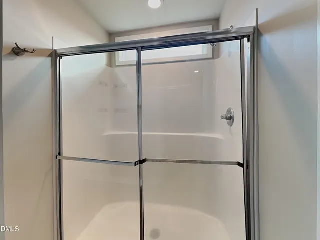 a bathroom with a glass shower door