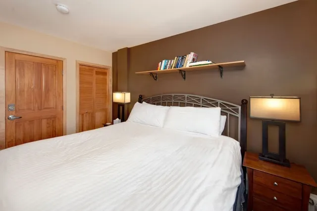 a bedroom with a bed and a lamp