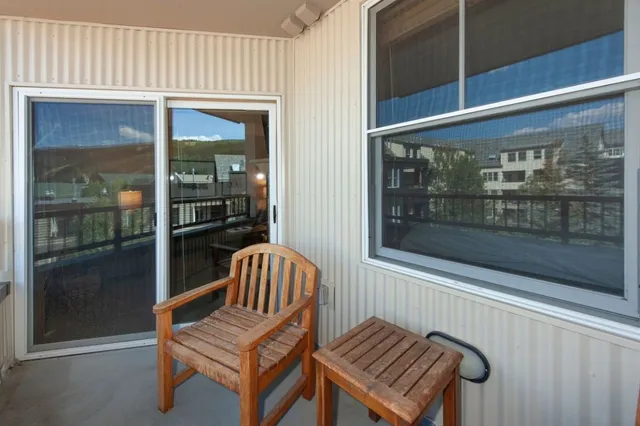 a living room with a couch and a large window with garden view