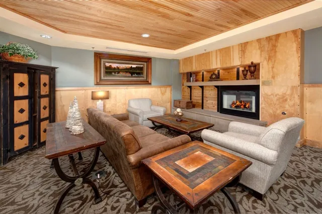 a living room with furniture a table and a wall painting