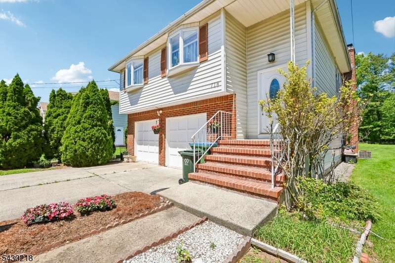 718 New Dover Road Edison, NJ 08820 - Photo 1 of 22 a front view of a house with a garden