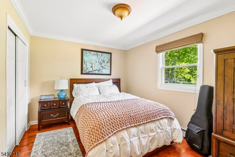 718 New Dover Road Edison, NJ 08820 - Photo 11 of 22 a bedroom with a bed a window and a flat screen television