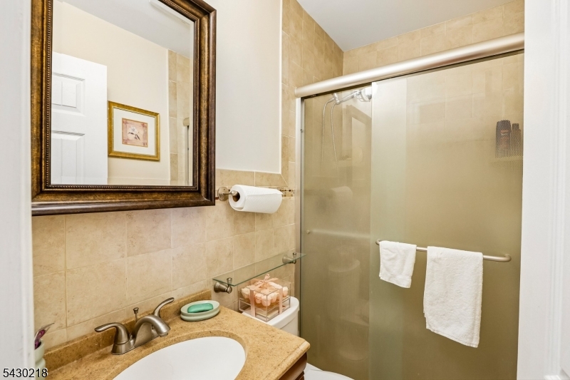 718 New Dover Road Edison, NJ 08820 - Photo 12 of 22 a bathroom with a sink and a mirror