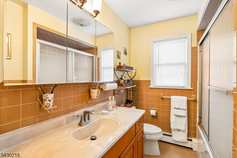 718 New Dover Road Edison, NJ 08820 - Photo 13 of 22 a bathroom with a sink toilet and shower