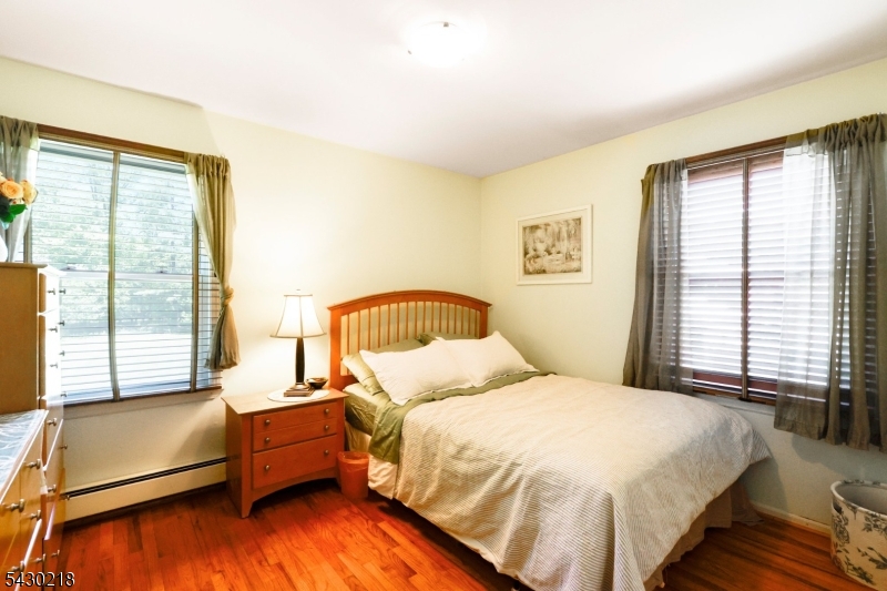 718 New Dover Road Edison, NJ 08820 - Photo 15 of 22 a bedroom with a bed and a large window