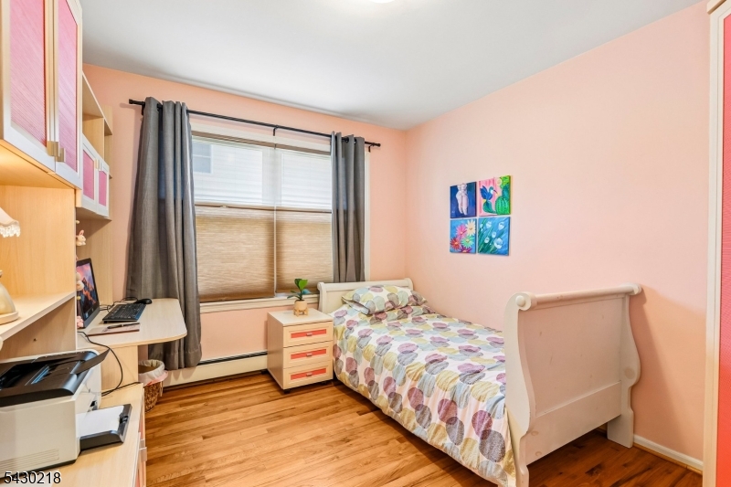 718 New Dover Road Edison, NJ 08820 - Photo 16 of 22 a bedroom with a bed and a large window