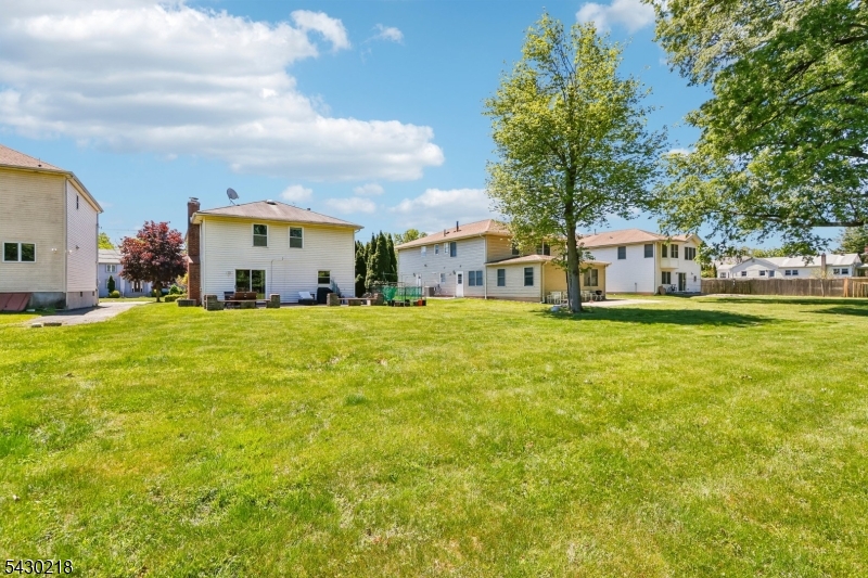 718 New Dover Road Edison, NJ 08820 - Photo 18 of 22 a view of a house with a big yard and large trees