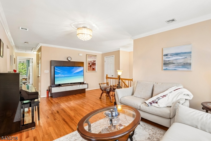718 New Dover Road Edison, NJ 08820 - Photo 5 of 22 a living room with furniture a flat screen tv and a table