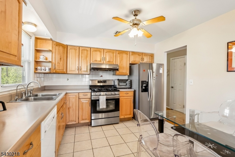 718 New Dover Road Edison, NJ 08820 - Photo 9 of 22 a kitchen with a sink appliances and cabinets
