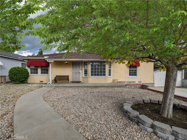 front view of a house with a tree