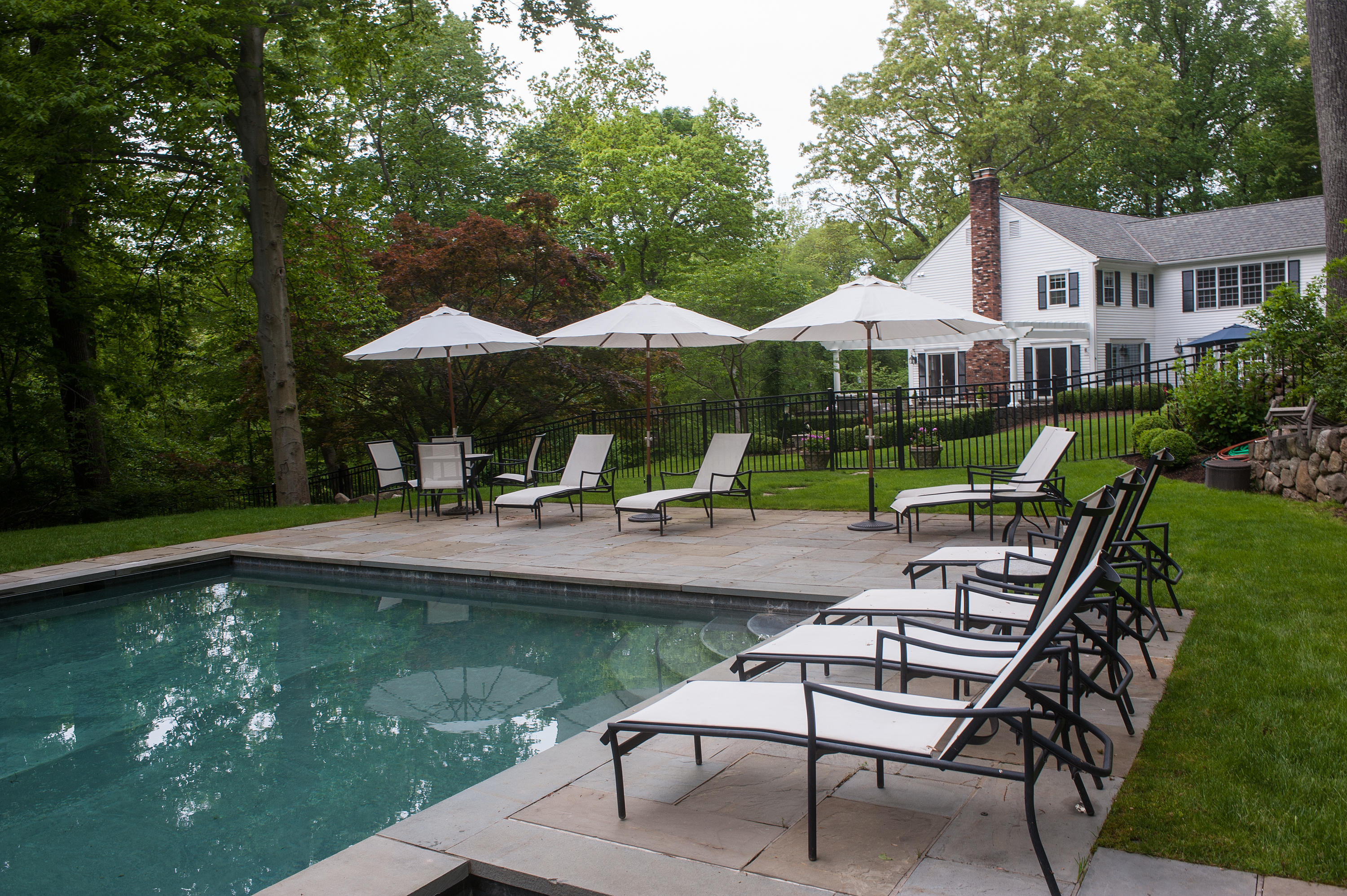 104 Logan Road New Canaan, CT 06840 - Photo 30 of 34 a view of house with swimming pool and outdoor seating
