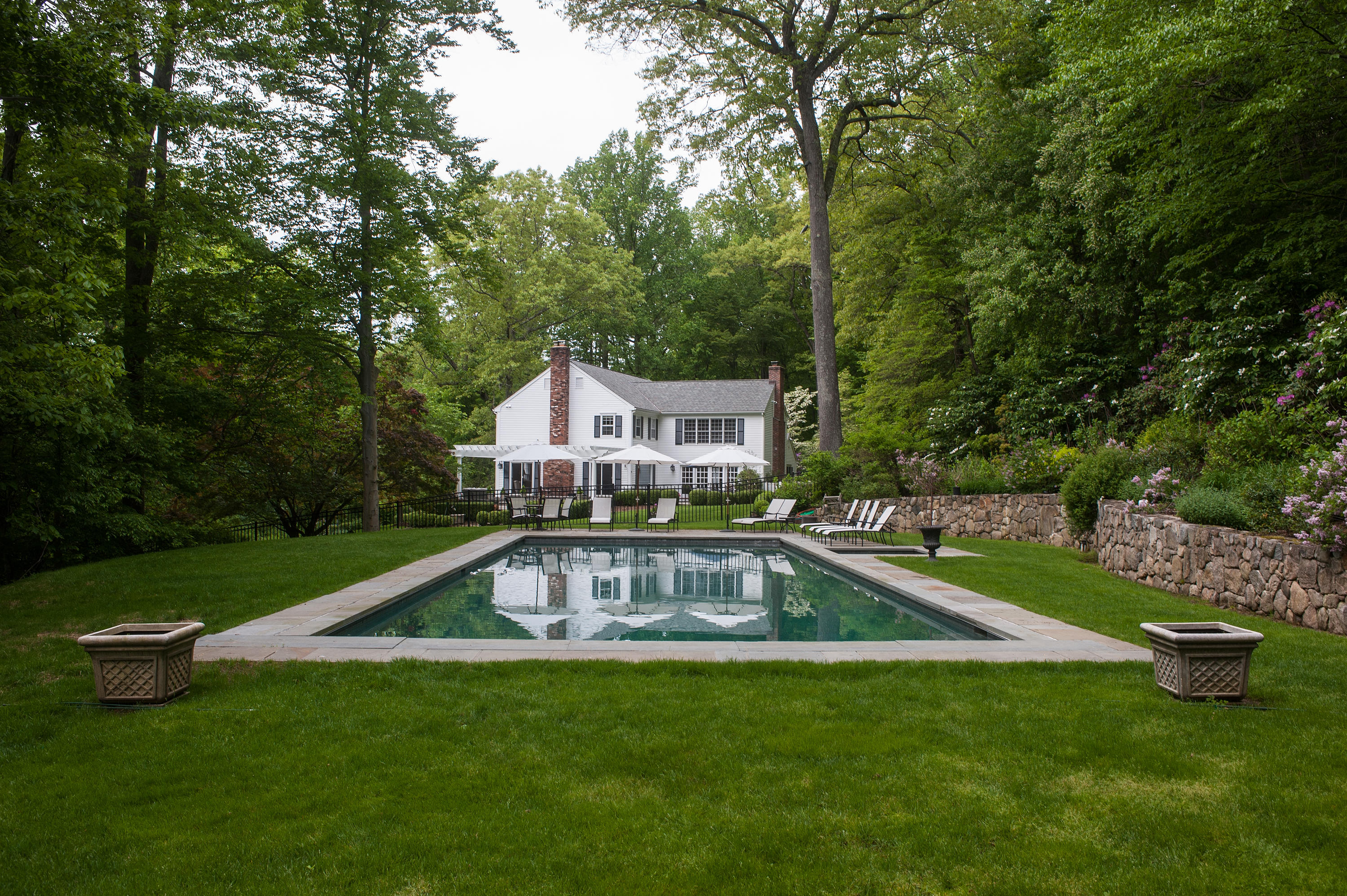 104 Logan Road New Canaan, CT 06840 - Photo 31 of 34 a view of a house with a yard