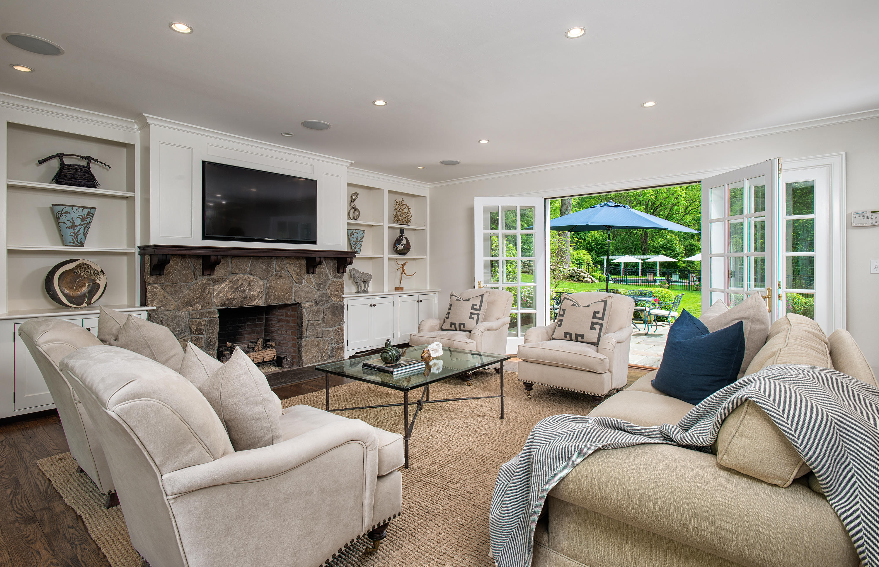 104 Logan Road New Canaan, CT 06840 - Photo 6 of 34 a living room with furniture a large window and a fireplace