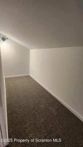 a bathroom with a tub a sink and mirror