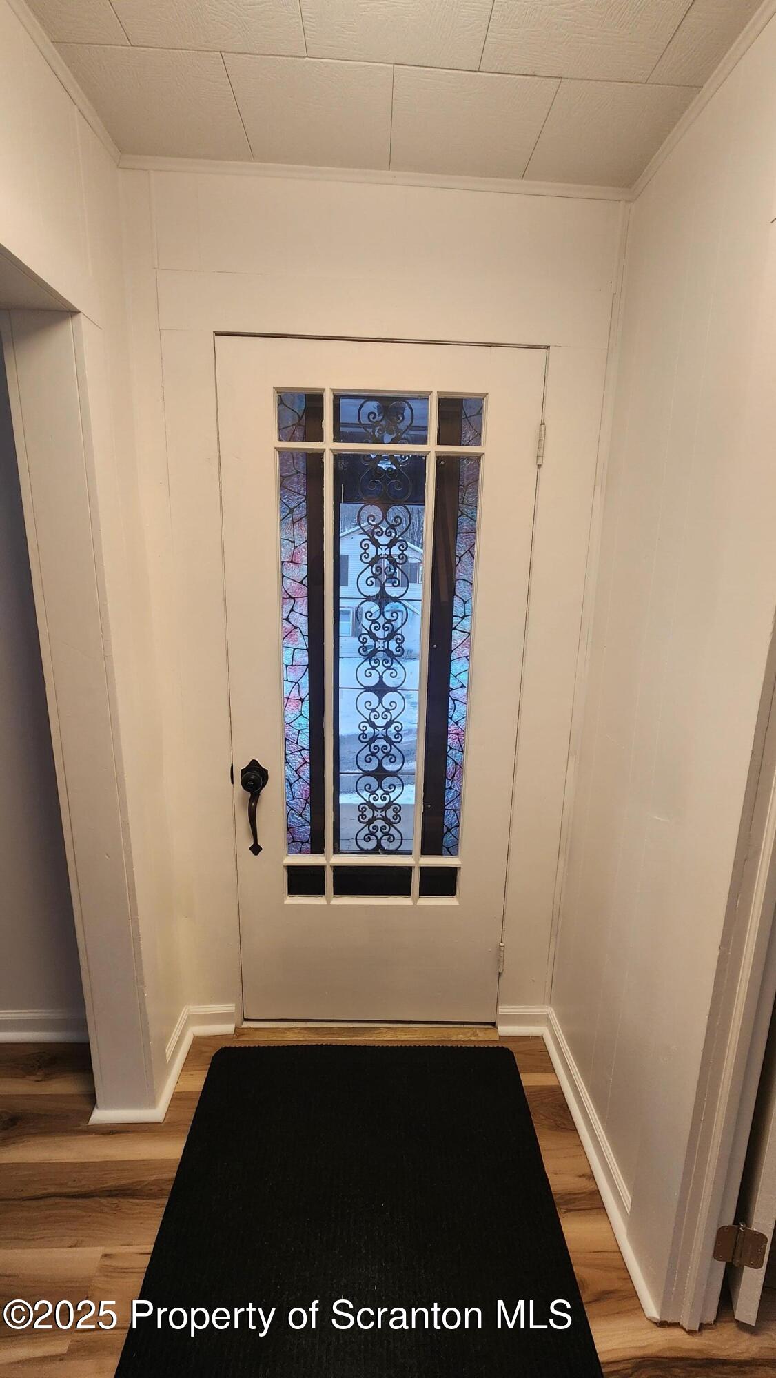38 Prospect Street Hop Bottom, PA 18824 - Photo 2 of 41 a view of an empty room with wooden floor and a window