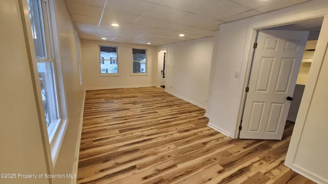 a view of a room with wooden floor and stairs