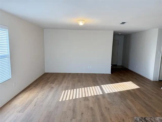 an empty room with wooden floor