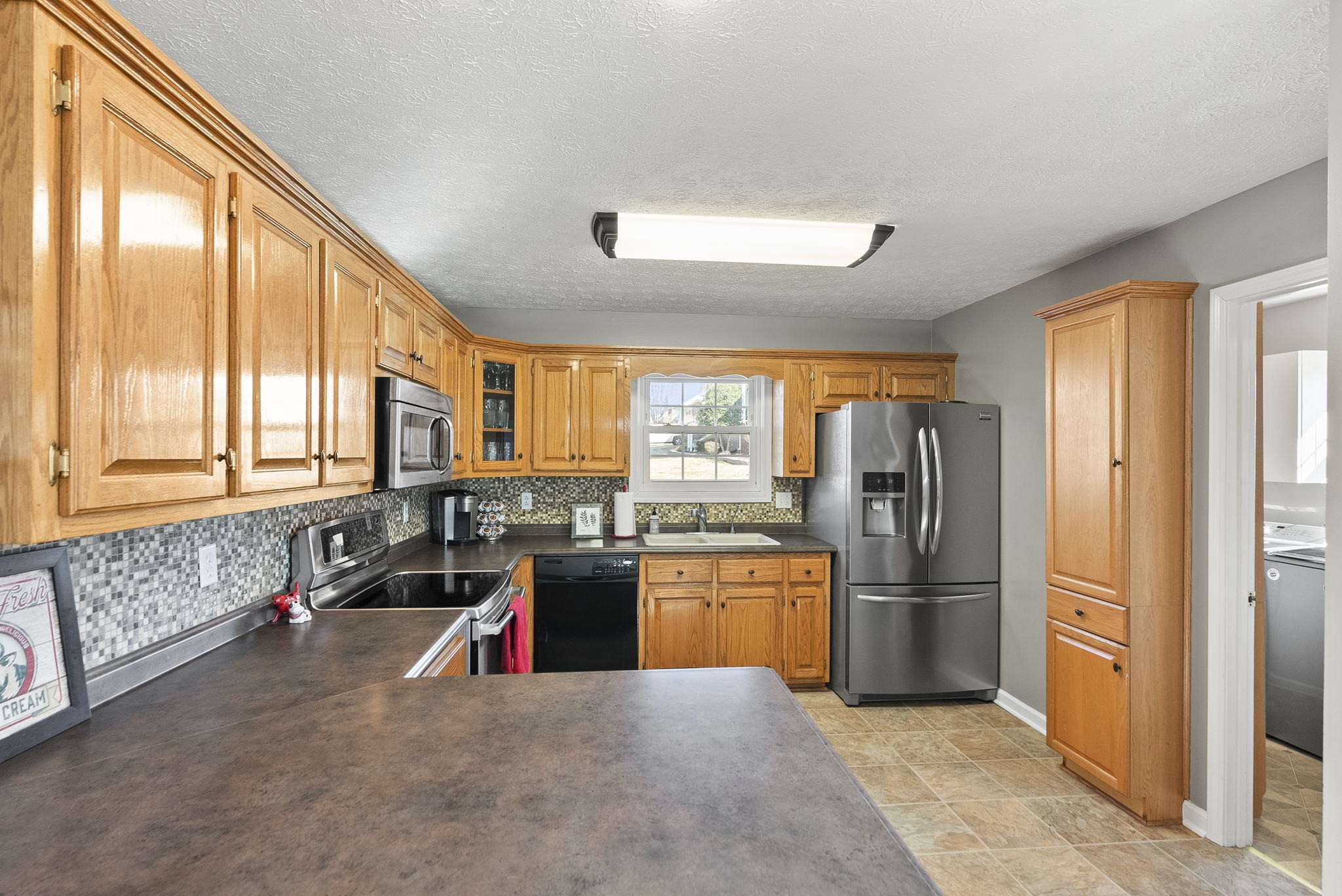 145 Kilgore Trace Cross Plains, TN 37049 - Photo 12 of 34 a kitchen with stainless steel appliances granite countertop a refrigerator and a sink