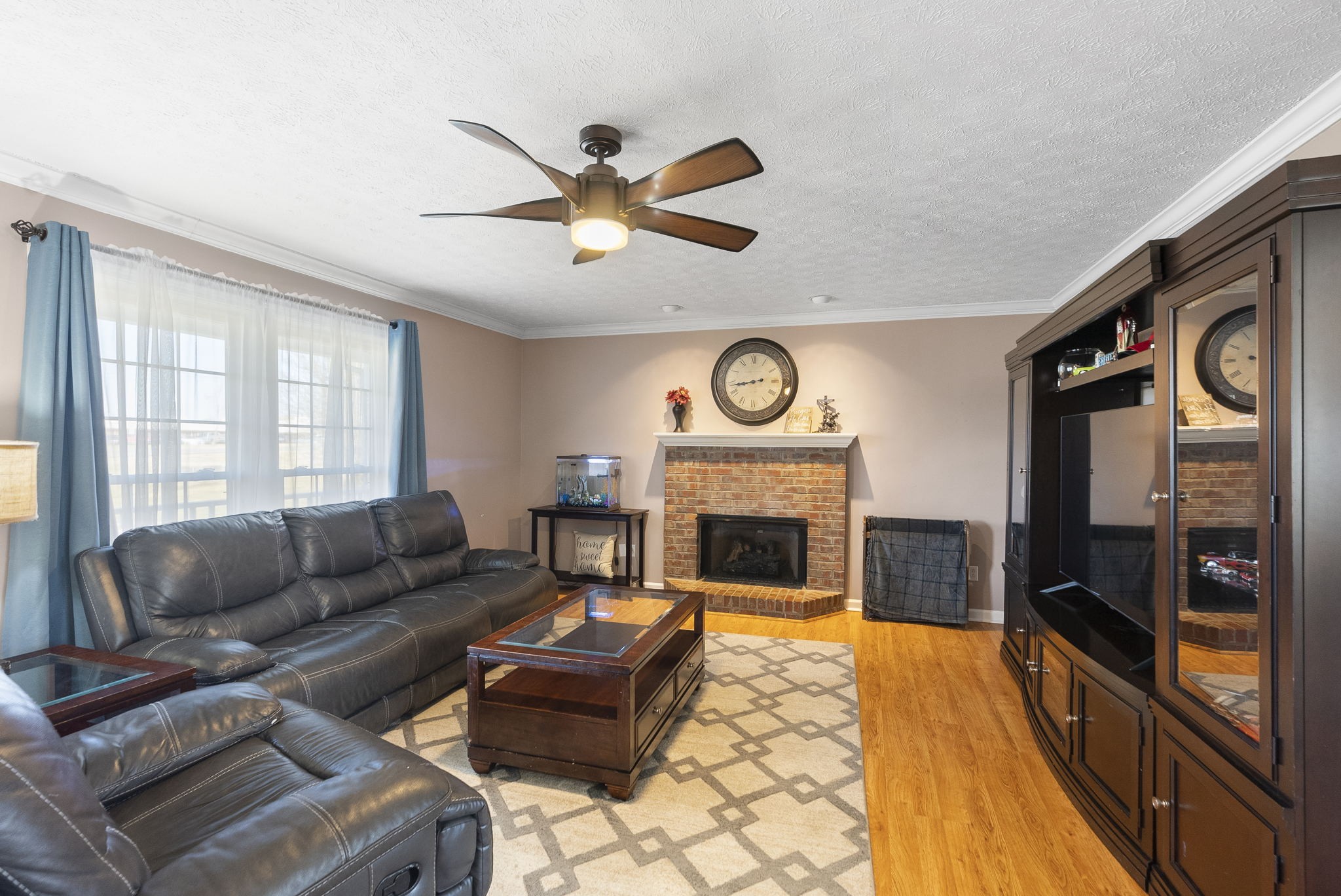 145 Kilgore Trace Cross Plains, TN 37049 - Photo 6 of 34 a living room with furniture a flat screen tv and a fireplace