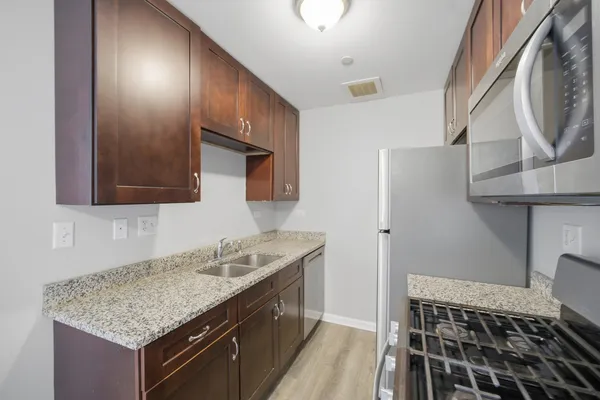 a kitchen with a sink stove and cabinets