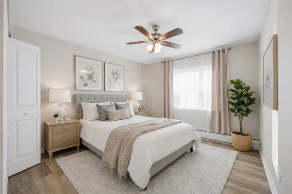 a bedroom with a large bed and a chandelier