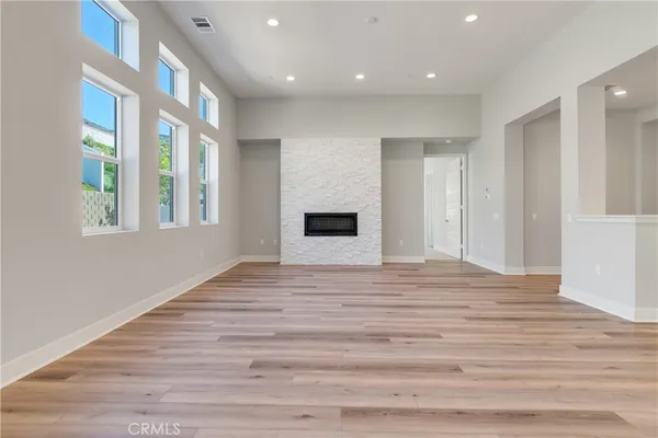 a view of empty room with wooden floor and entryway