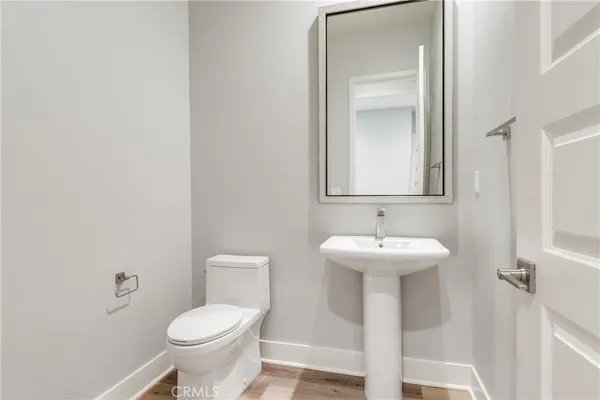 a bathroom with a sink toilet and a mirror