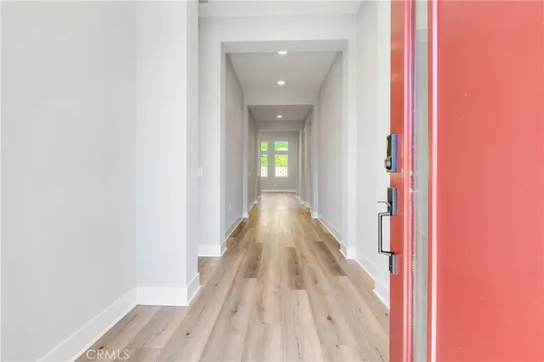 a view of a hallway with wooden floor