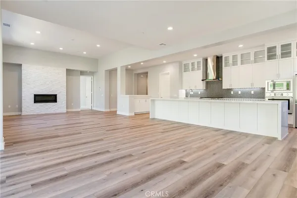a view of large kitchen with granite countertop cabinets and wooden floor