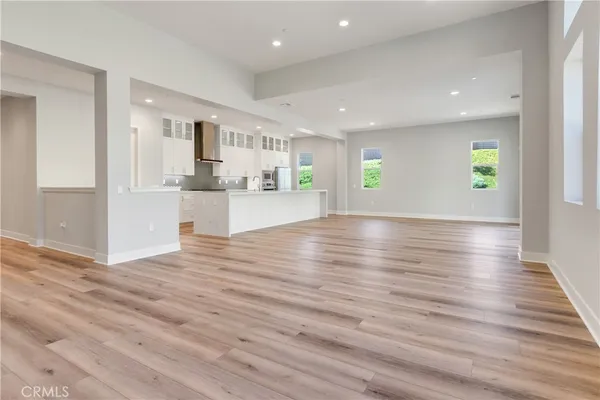 a view of kitchen and hall with wooden floor