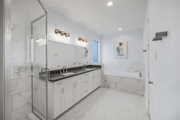 a bathroom with a granite countertop sink a toilet a mirror and shower