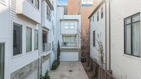 a view of a brick house with a door and windows