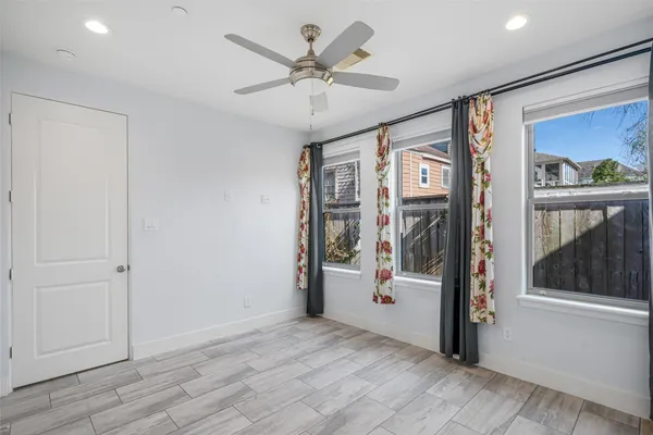 a view of an entryway with wooden floor and livingroom